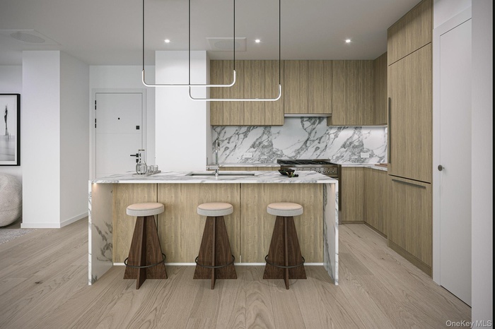 Kitchen with light stone counters, brown cabinetry, light wood-style flooring, modern cabinets, and recessed lighting