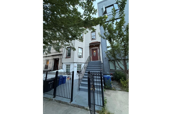 View of front of house featuring a fenced front yard and a gate