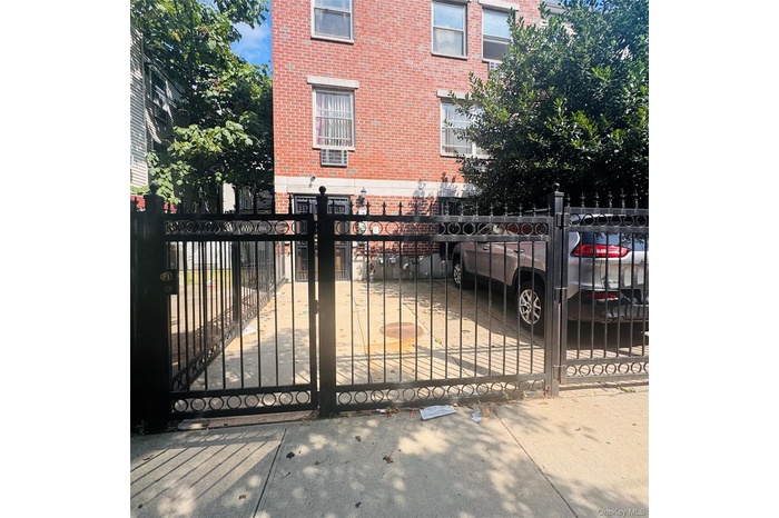 Gate with a fenced front yard and a balcony