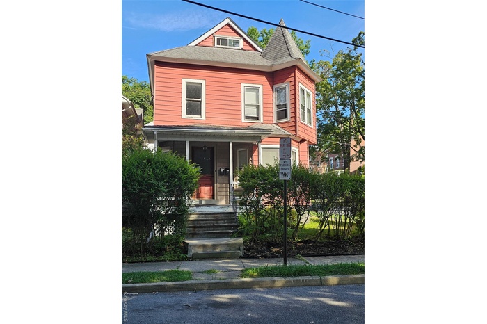 View of front of house with a porch and a shingled roof