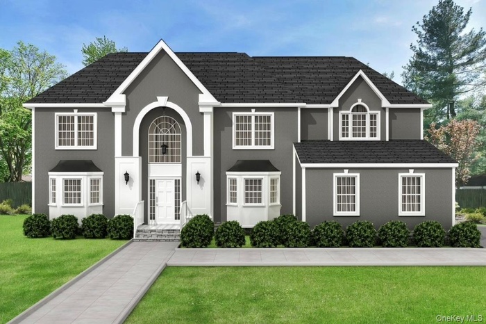 View of front facade with a front lawn and stucco siding