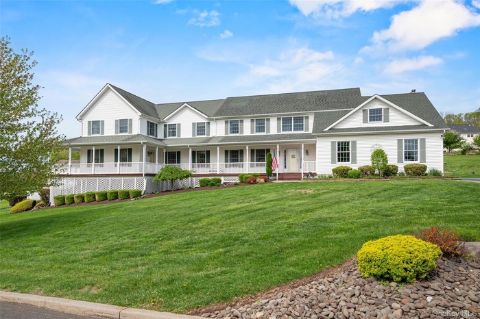 View of front of property featuring covered wrap-around porch. Only a couple steps to main door AND separate entrance to Accessory Apartment which is