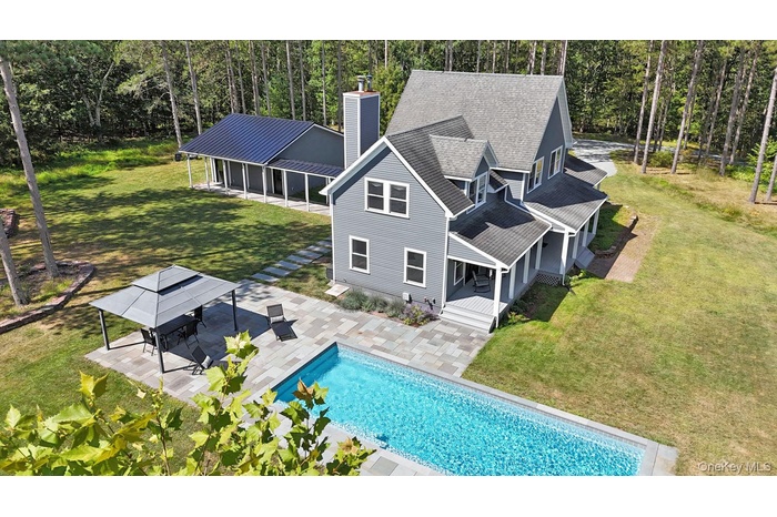 Aerial view of property and surrounding area featuring a pool