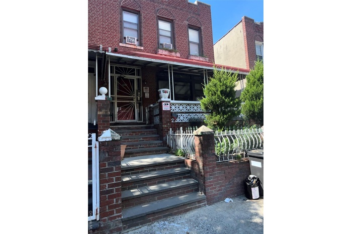 View of front of property with a porch and brick siding