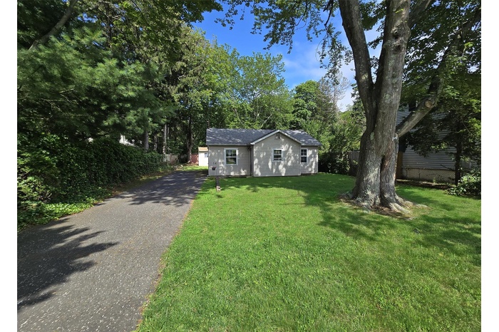 Ranch-style house with driveway and an outdoor structure