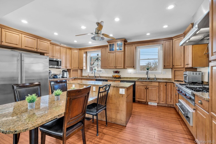 Huge Kitchen has 2 Dishwashers, 2 Ovens, 2 Sinks, Large SubZero refrigerator, & attached stone table for informal dining, working on Laptop or enterta