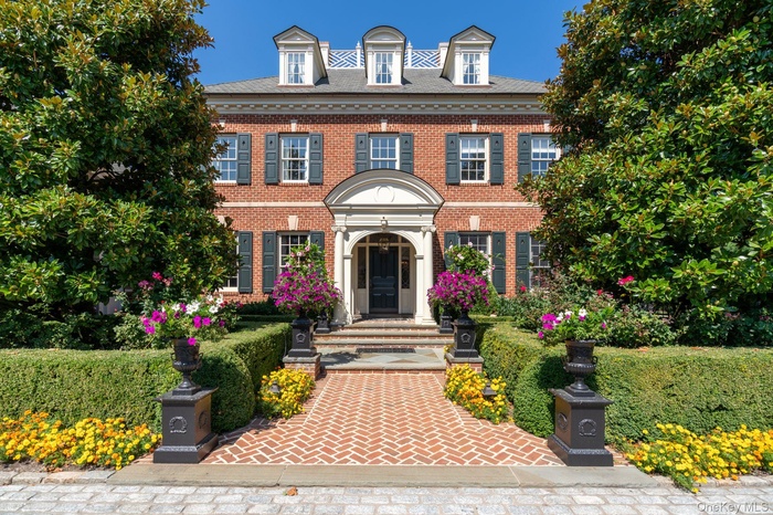 Colonial-style house with brick siding