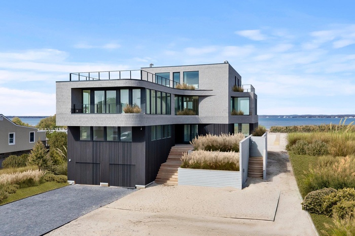 Modern home with a water view and a balcony