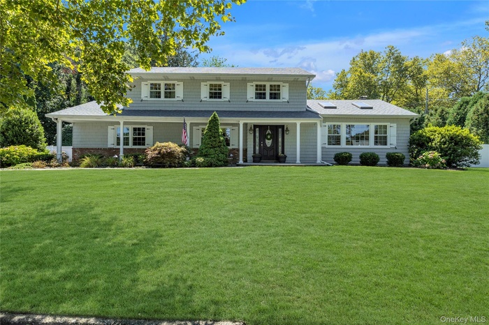 Traditional-style home with a porch and a front lawn