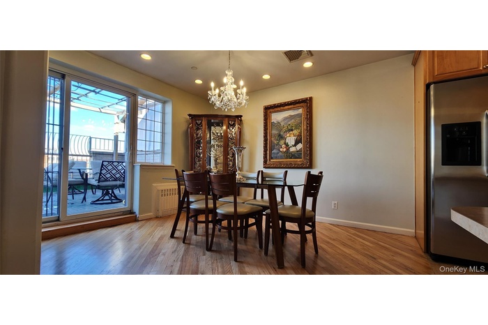 Dining space featuring a chandelier, light wood finished floors, recessed lighting, and radiator heating unit