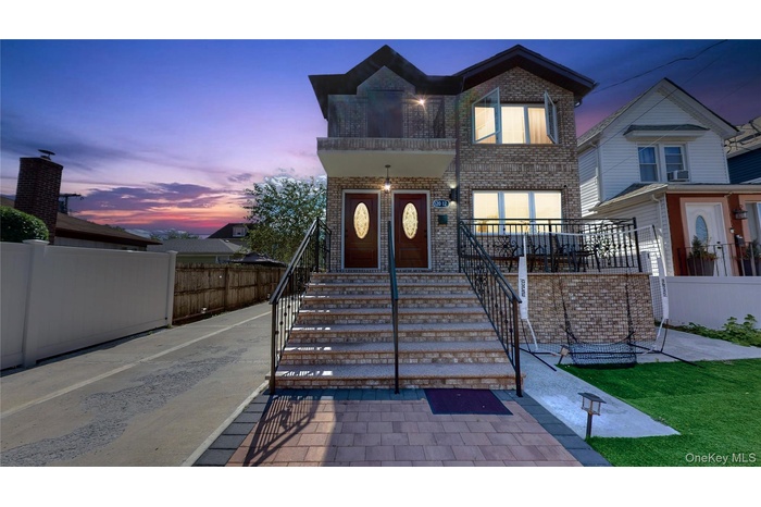 View of front of property featuring brick siding and stairway
