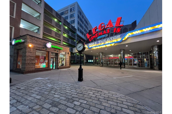 Property at twilight featuring view of commercial area