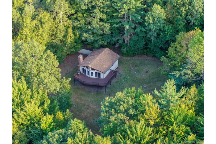View of subject property featuring a forest