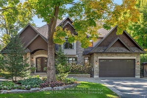 Visit Rockcliffe Park to discover a stunning home of stone, arched windows, stately pillars, double garage, and magnificent peaks.