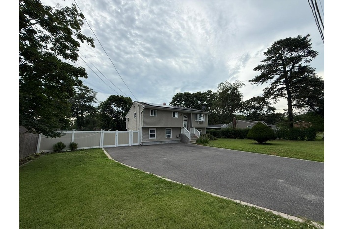 View of front facade featuring asphalt driveway