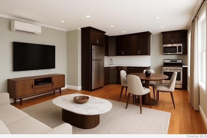 Virtually Staged Kitchen featuring light countertops, dark brown cabinets, stainless steel appliances, light wood-style flooring, and recessed lightin