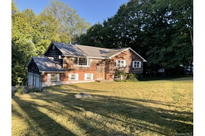Rear view of property featuring a yard