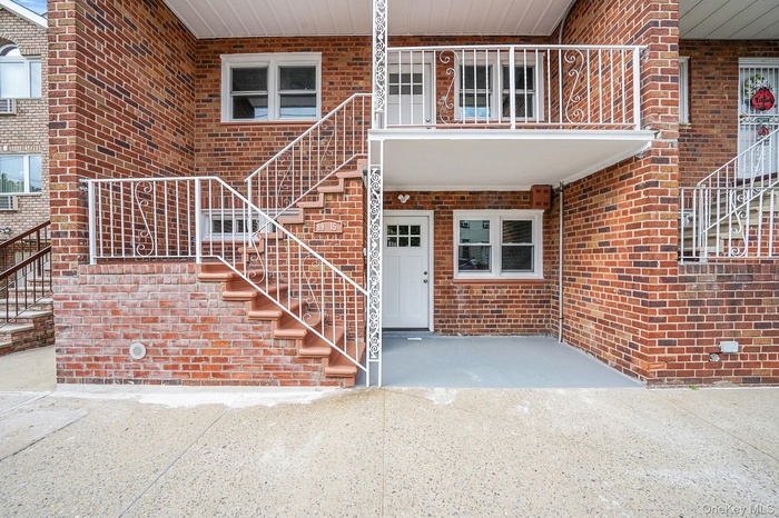 Entrance to property with brick siding and a patio area
