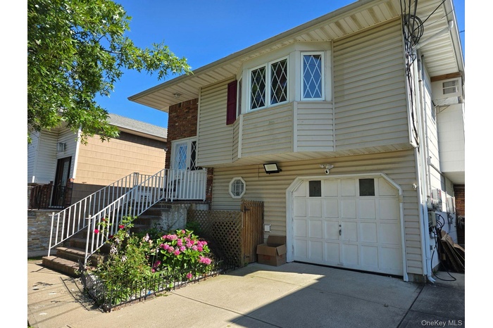 View of front of property with a garage and concrete driveway