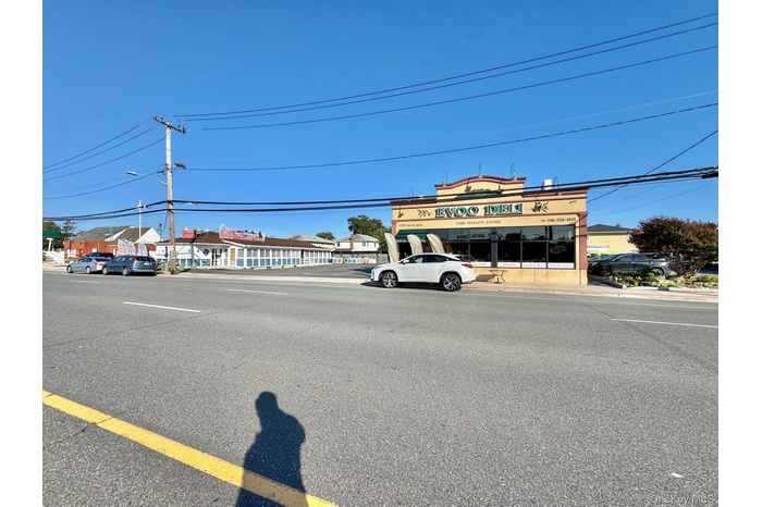 View of asphalt street with street lights and curbs