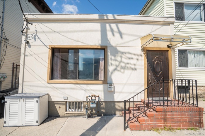 Entrance to property with stucco siding
