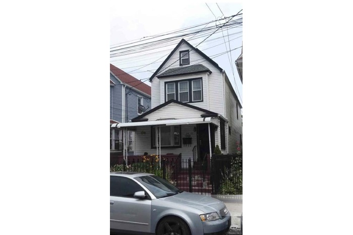 American foursquare style home featuring a fenced front yard and a gate