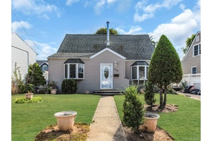 NEW ENGLAND CAPE COD HOME WITH REAR DORMER.