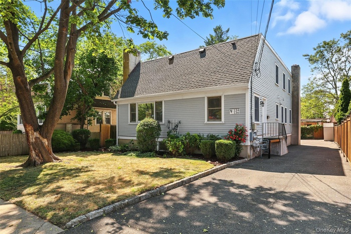Front of Two Family Home with a chimney and roof with shingles