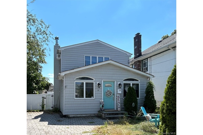 View of front of house featuring a gate and a chimney