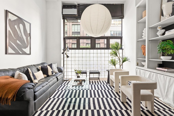 Living area featuring floor to ceiling windows