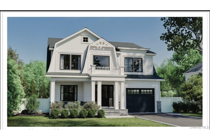 View of front of house with a balcony, an attached garage, and asphalt driveway