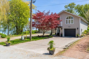 Where waves compose your morning soundtrack and golden sunsets close each day, this two bed, three bath lakefront retreat delivers the lakefront life you've pinned to every vision board.