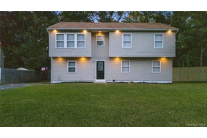 Welcome to 25 Nord Park Blvd in Middle Island, a fully renovated hi ranch offering an impressive 8 bedrooms, perfect for large families.