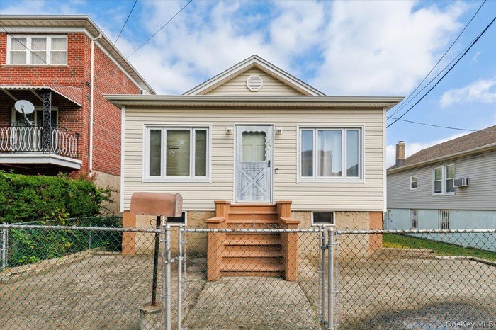 View of front of property featuring a gate and a fenced front yard
