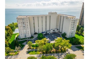 Step into Unit 404 at 5280 Lakeshore Road, an exceptional WATERFRONT corner condo with captivating clear lake views.