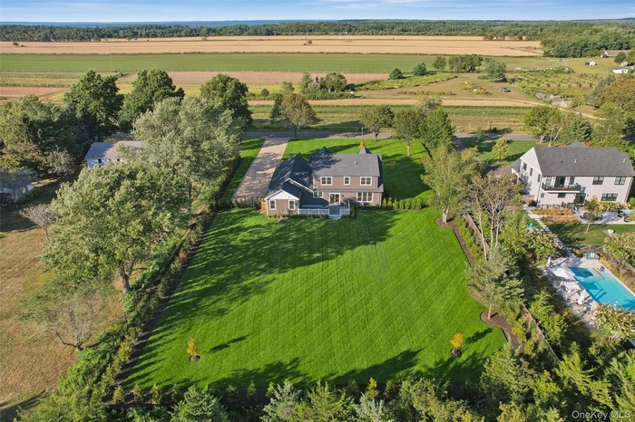 Aerial view of property and surrounding area with rural landscape and a pool area