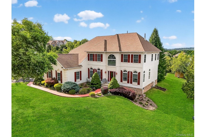 View of front of property featuring a front yard and a shingled roof