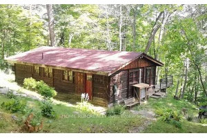 Nestled on a huge lot, just 40 minutes from Ottawa, this charming water front 4 season cottage is enveloped by a lush green oasis on a 1.