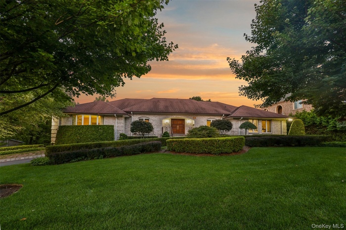 Ranch-style house with a front yard and brick siding