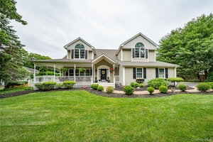 This Magnificent custom built home with wrap around porch is set over on over an acre of level property.