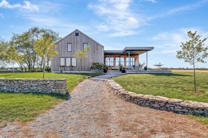 Nestled in the rolling hills of Hillier, 1164 Danforth Road is a modern country retreat where design and nature are in perfect harmony.