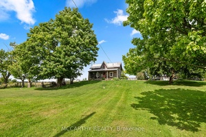 Step into the dream of rural living with this captivating log home set on 9.