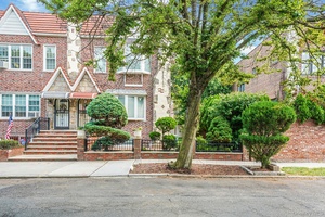Welcome to this rare semi detached legal two family Tudor home, perfectly situated in the heart of Middle Village.