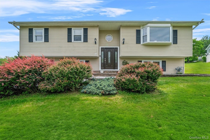 Split foyer home with a front lawn