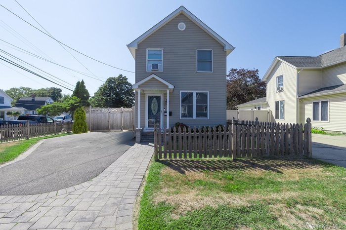 Traditional-style home featuring a fenced front yard