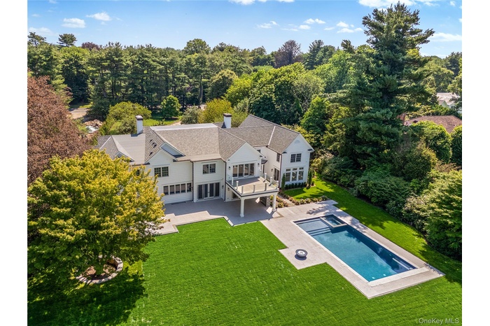Welcome to 42 Mamaroneck Road in Scarsdale. This iconic estate is nestled on 1.5 acres within Heathcote's sought-after Murray Hill estate neighborhood