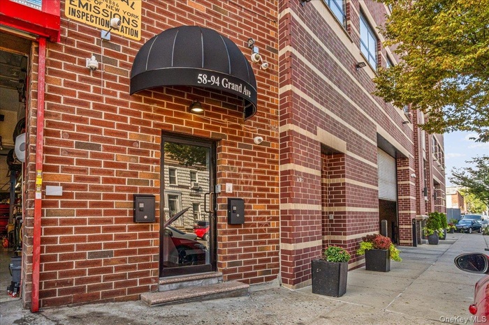 Doorway to property featuring brick siding