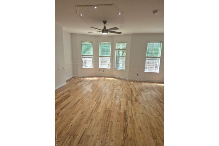 Unfurnished room featuring healthy amount of natural light, light wood-type flooring, recessed lighting, and attic access