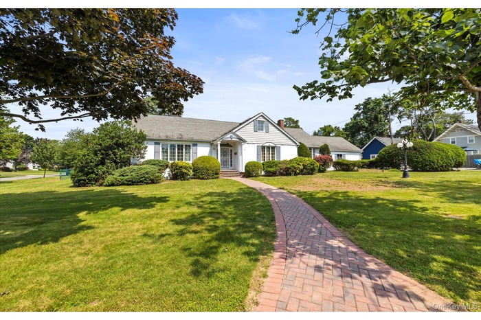 1946 Colonial-style home featuring mature landscaping