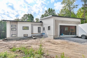 Welcome to this bright and contemporary bungalow, perfectly set on a stunning wooded 1.